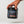 A hand holding a black tub of iAMINOS Athlete Pro+ performance powder against a clean light gray background.